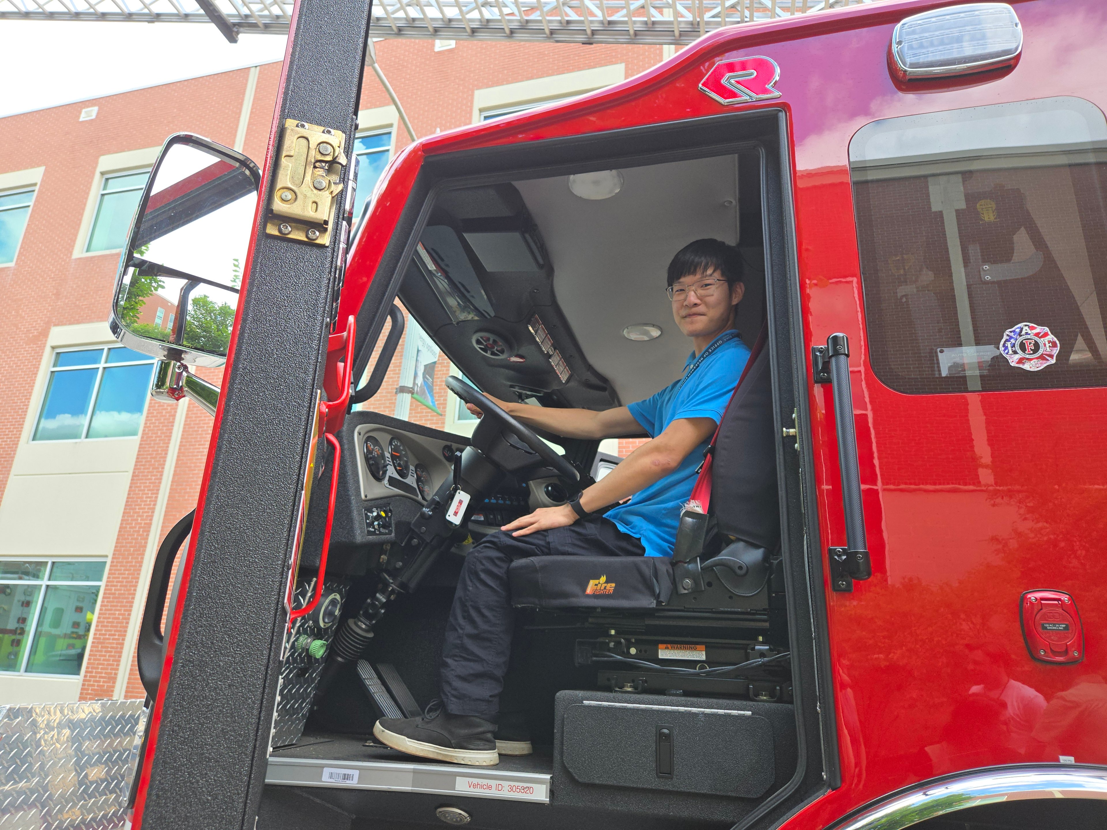 Damien Staebler sitting in the driver seat of a fire engine during an internship activity